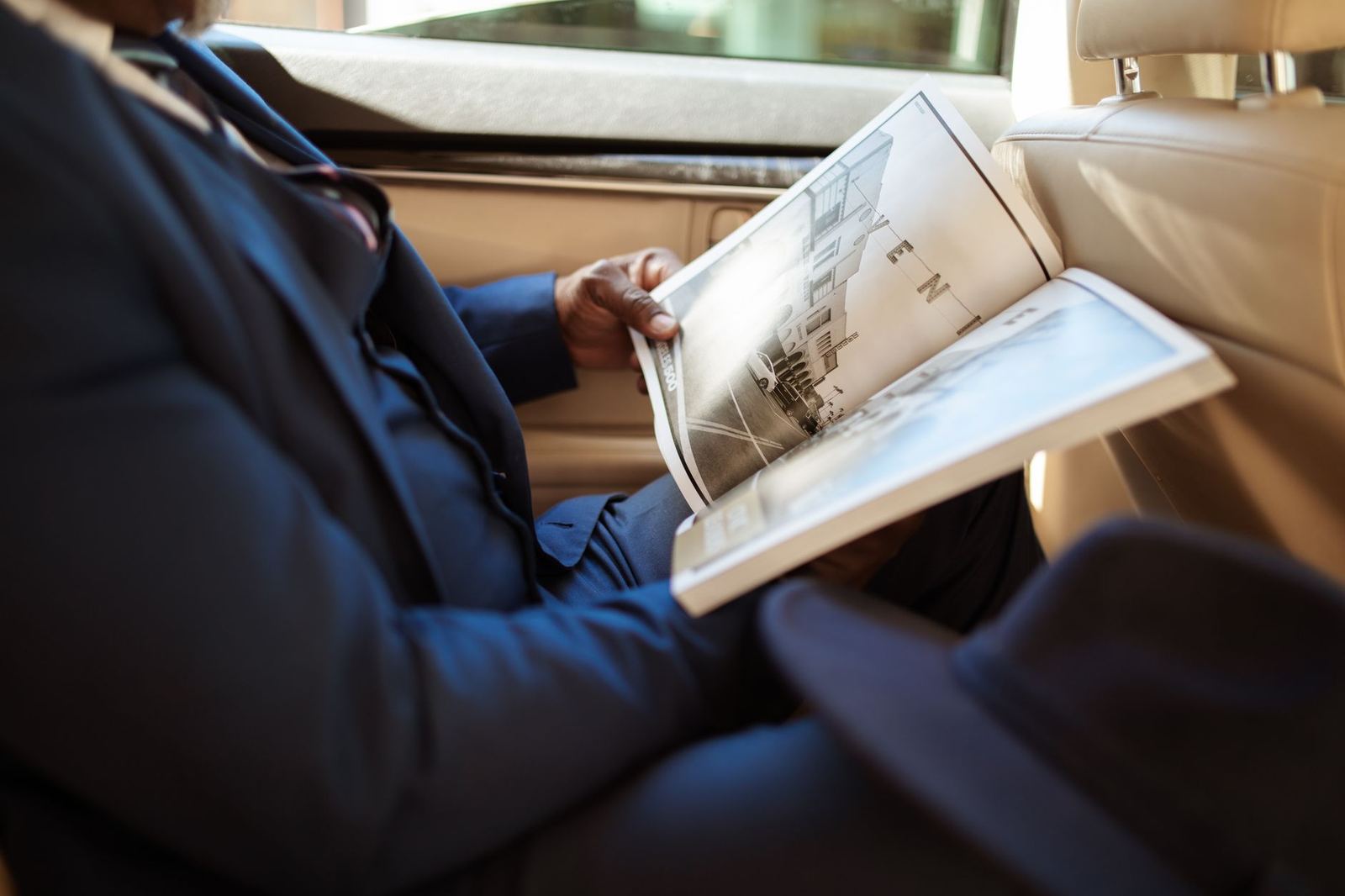 Executive working in the rear seat of a chauffeured car