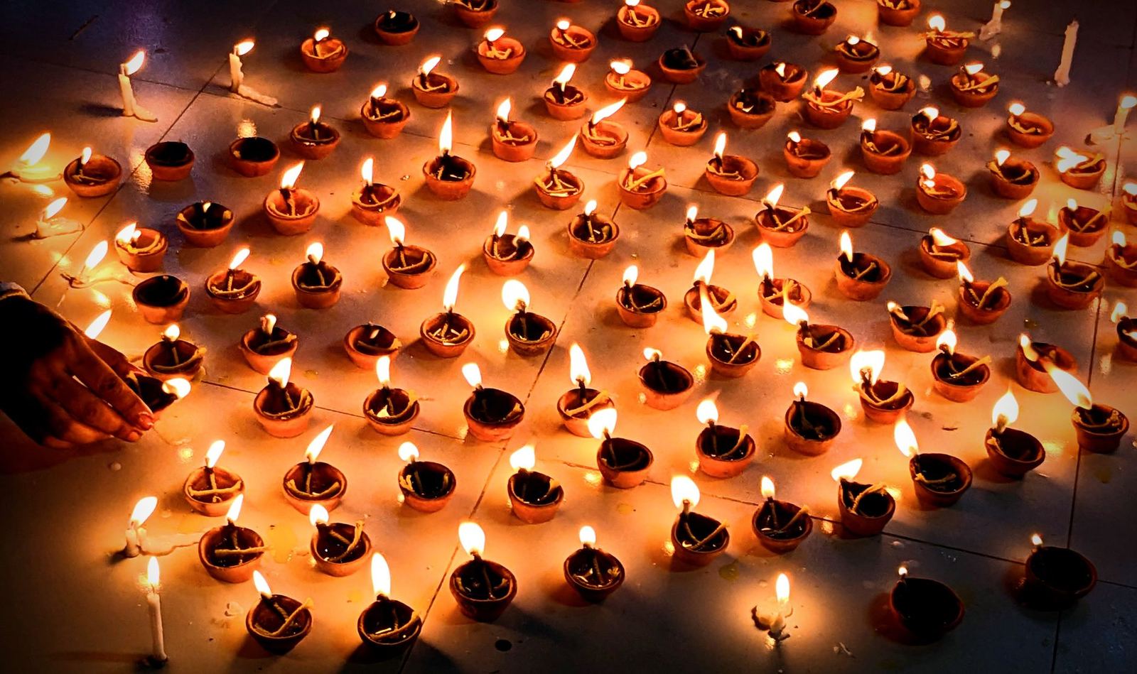 Rows of lit oil lamps at Diwali