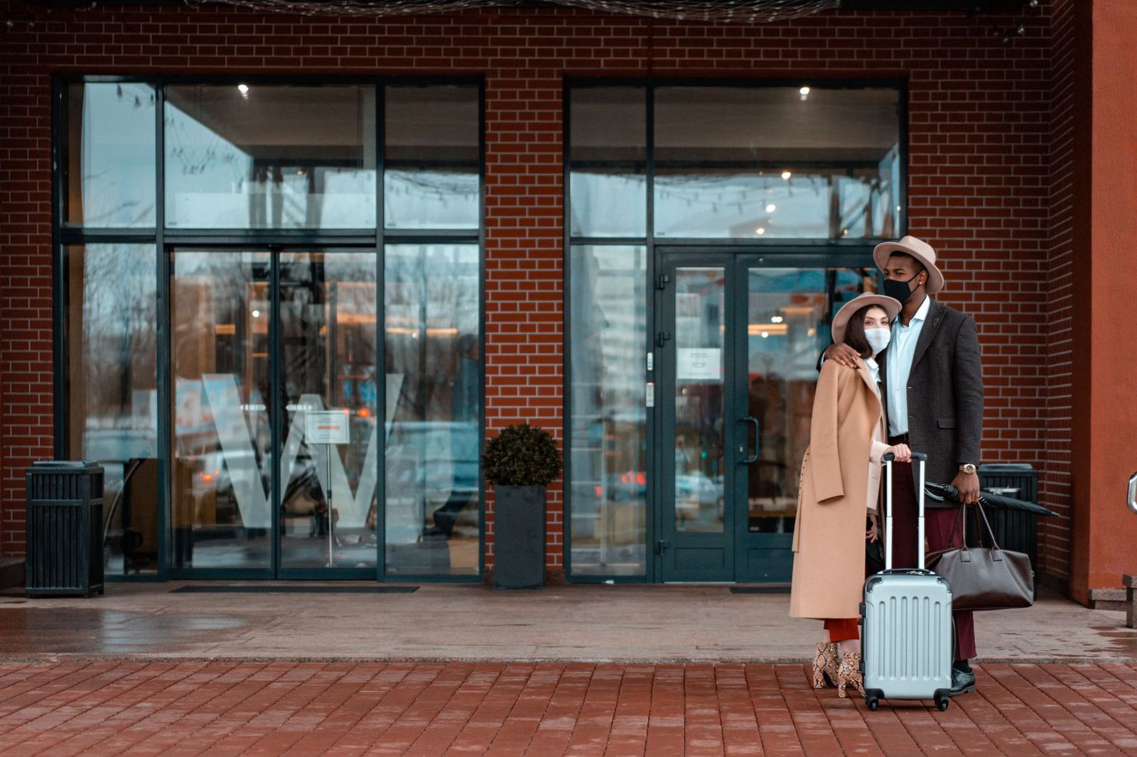 Couple with suitcases arriving in a hotel room